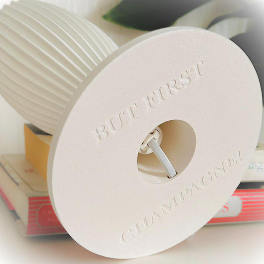 White cylindrical object with text on a blurred background