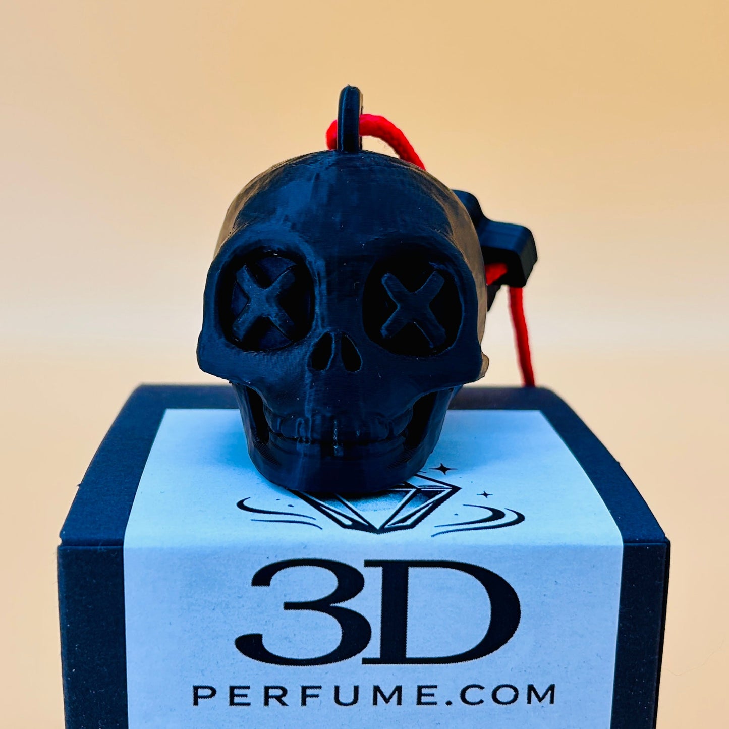 Black skull-shaped perfume bottle on a blue box with '3D Perfume.com' branding.