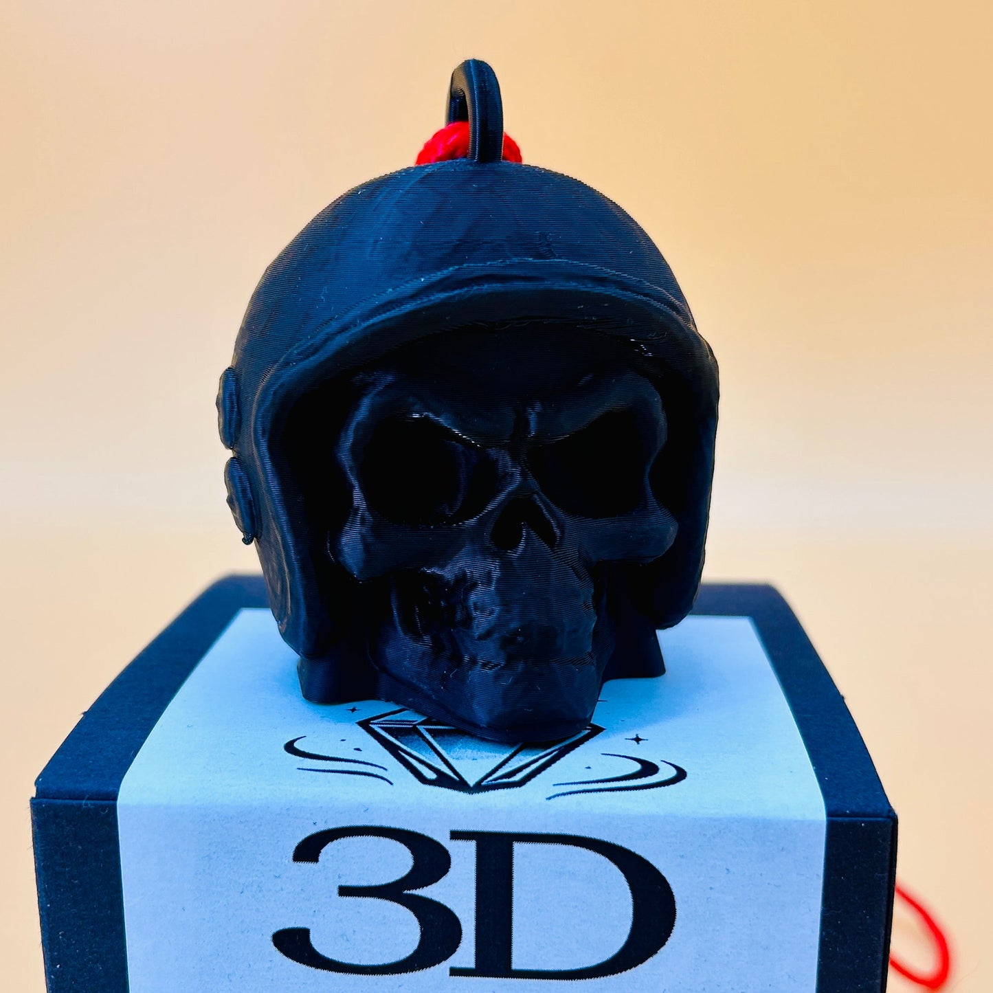 Black skull-shaped perfume bottle on a blue stand with '3D Perfume.com' label.