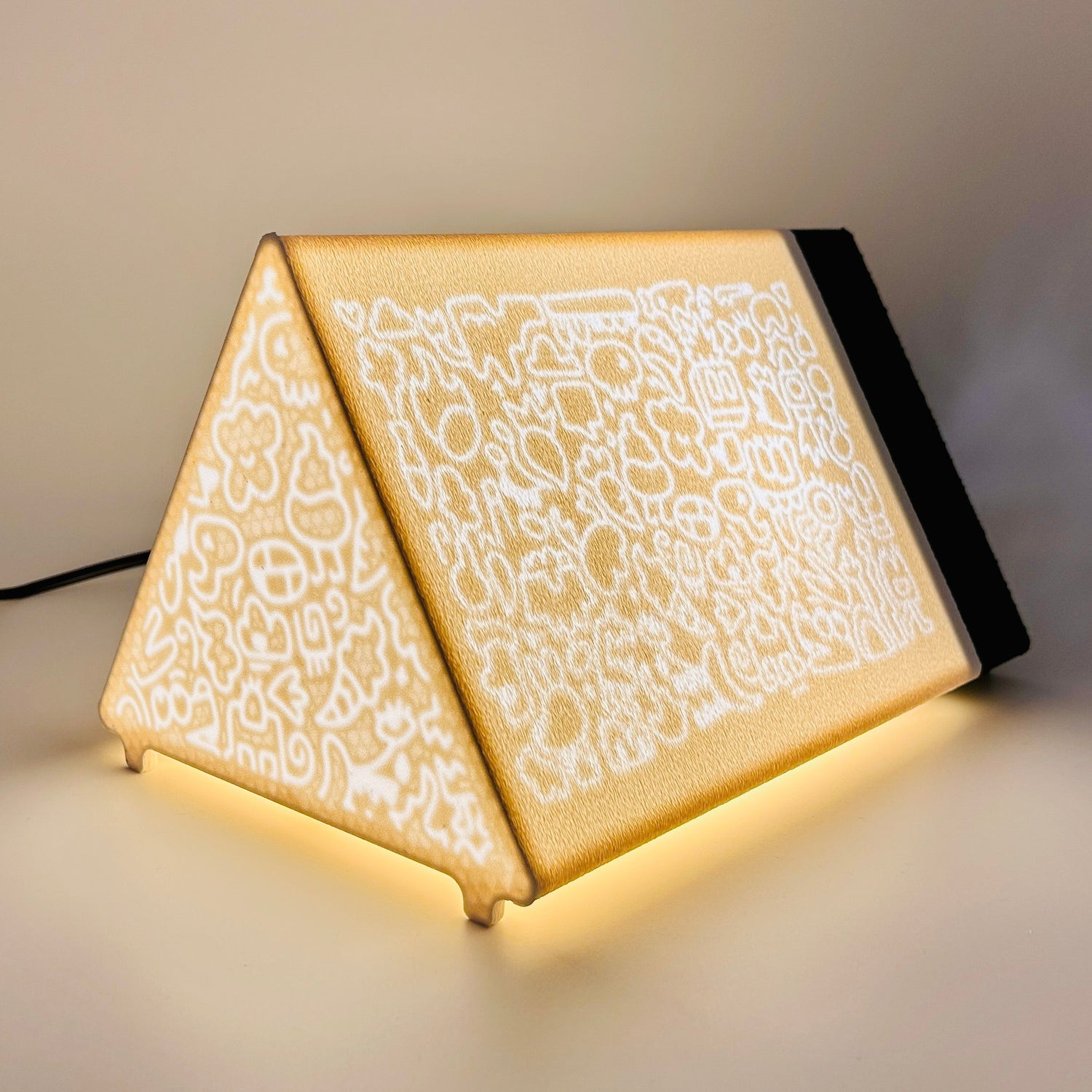 Book rest 3D printed lamp with a doodling pattern on white background